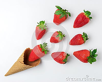 Ice cream cone with strawberries on white background. Minimal summer concept Stock Photo