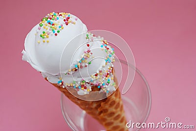 Ice Cream cone with scoop of Vanilla ice cream in glass on Pink background. top view. Party, dessert, summer concept. Stock Photo