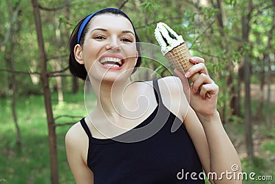 Ice cream. Cute and cheerful woman with ice cream in hand. Tasty Stock Photo