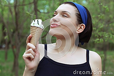 Ice cream. Cute woman with ice cream in hand. Tasty dessert. Stock Photo