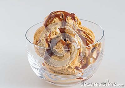 Ice cream in glass bowl - Caramel and vanilla ice cream drizzled Stock Photo
