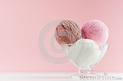 Ice cream scoops different flavor - strawberry, chocolate, creamy in transparent glass ice-cream bowl in modern pink color. Stock Photo