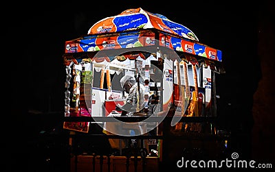 ICE CREAM SELLER AT NIGHT NEAR A PARK WAITING FOR BUYERS Editorial Stock Photo