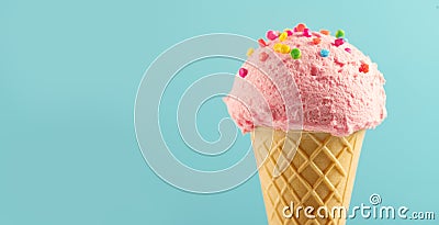 Ice cream. Strawberry or raspberry flavor icecream in waffle cone over blue background. Sweet dessert Stock Photo