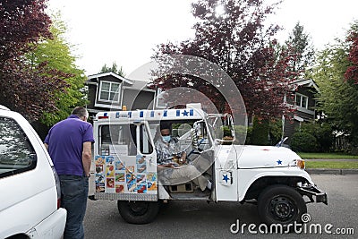 An ice cream truck in the residential area during covid pandemics Editorial Stock Photo