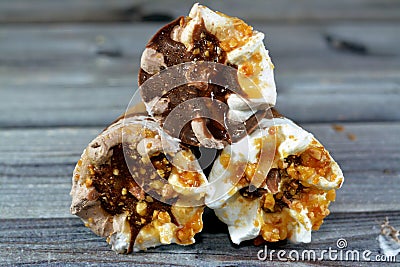 Ice cream vanilla and chocolate cones with topping of chocolate and caramel sauce and nuts in a crispy wafer cones, melting cold Stock Photo
