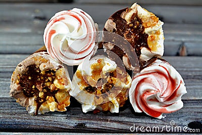 Ice cream vanilla and chocolate cones with topping of chocolate and caramel sauce and nuts in a crispy wafer cones, melting cold Stock Photo