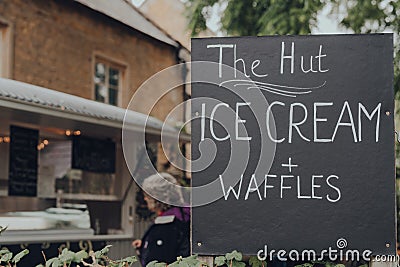 Ice Cream and Waffles sign for The Hut street food vendor in Bourton-on-the-Water, Cotswolds, UK Editorial Stock Photo