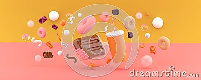 Ice cream and water among the donuts on an orange and pink backdrop. Stock Photo