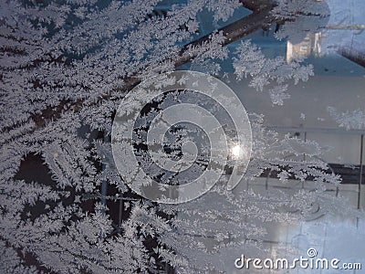 Ice crystals on glass on a frosty day. Patterns of frost. Stock Photo