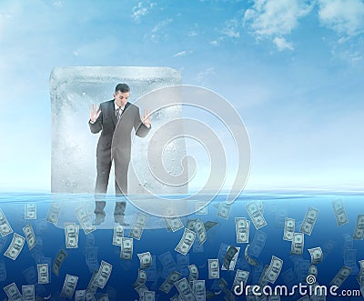 Ice cube with a businessman floating in the sea Stock Photo
