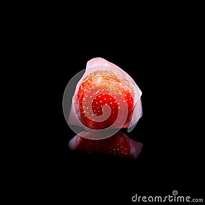 Ice cube and strawberry isolated on a black background Stock Photo