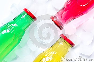 Ice cubes and bright bottles on white background top view mock up Stock Photo