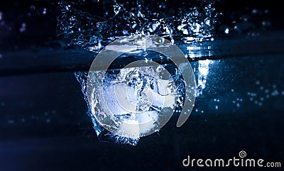 Ice Cubes Entering Water Stock Photo