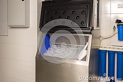 Ice cubes store in ice making machine for clean product. Ice cube maker. Cube ice machine. Suitable for small beverage shops. Stock Photo