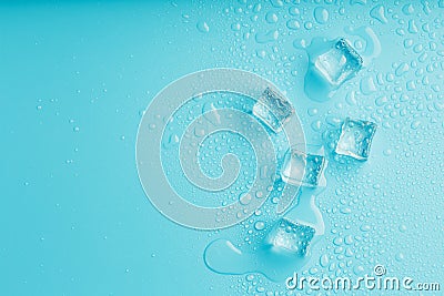 Ice cubes with water drops scattered on a blue background, top view Stock Photo