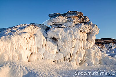 Ice dragon from frozen rock, fantastic winter landscape, closeup Stock Photo