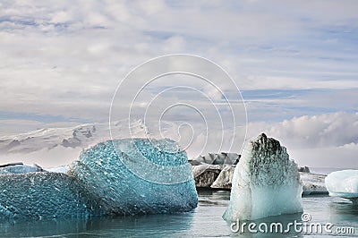 Ice floating in Iceland sea with high mountains in the background Stock Photo