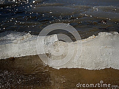 Ice floe floats at the surface of clean spring water. Glittering ice Stock Photo