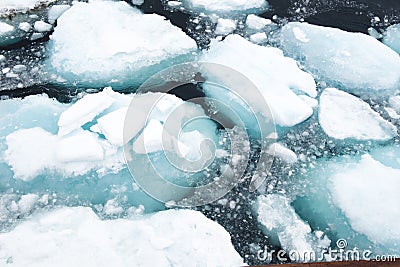 Drift Ice with turquoise shining water in Greenland Stock Photo