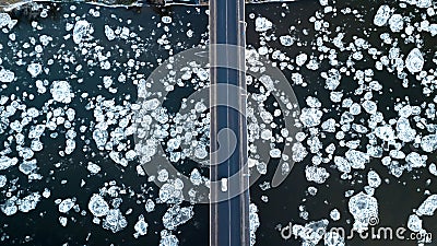 Ice floes floating on the river. River bridge. bird`s eye view Stock Photo