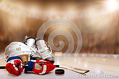 Ice Hockey Helmet, Skates, Gloves, Stick and Puck in Rink Stock Photo