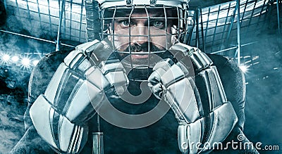 Ice Hockey player in the helmet and gloves on stadium with stick. Stock Photo