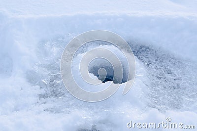 Ice hole drilled in ice ready for fishing on ice Stock Photo