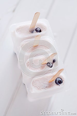 Ice popsicles with yogurt and blueberries in ice lolly mold Stock Photo