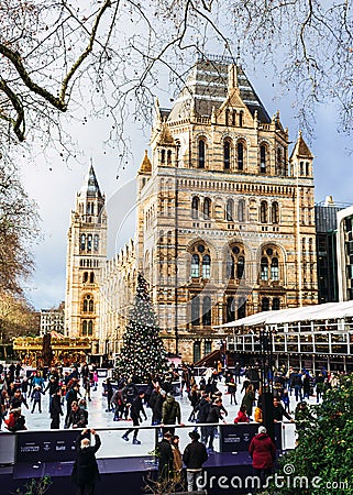 London, UK/Europe; 21/12/2019: Ice rink and Christmas tree at Natural History Museum in London. People enjoying ice skating at Editorial Stock Photo