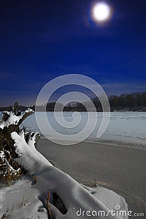 Ice on the river lit by moonlight. Stock Photo