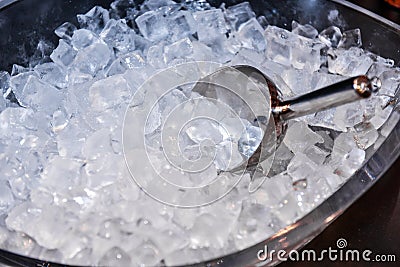 Ice with scoop in ice bucket Stock Photo