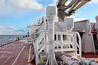 Ice of the ship and ship structures after swimming in frosty weather during a storm in the Pacific Ocean. Stock Photo