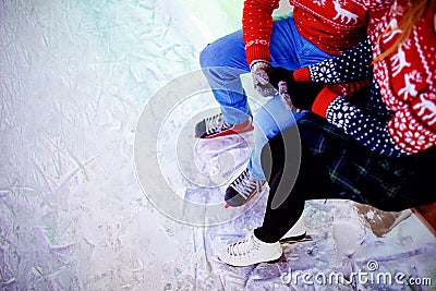 Ice skating lover couple having fun on snow winter holidays night illumination Stock Photo