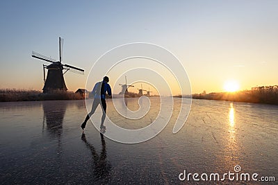 Ice skating at sunrise in the Netherlands Stock Photo