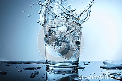 Beautiful splash of water on a blue background Stock Photo