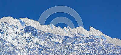 Ice structure plate on a blue background from the refrigeration equipment, cool in the summer heat Stock Photo