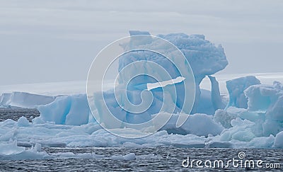 Iceberg in Antarctic Sound with a Glacier in the Background Stock Photo