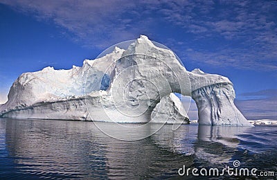 Iceberg with an Arch, Antarctica Stock Photo