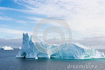 Iceberg with gate, beautiful shaped iceberg, surrounded by turquoise shiny water, Greenland Stock Photo