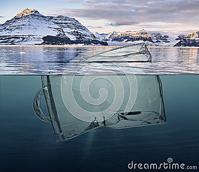 Iceberg of garbage plastic floating in ocean with greenland back Stock Photo