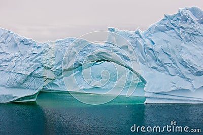 Iceberg with gate in Antarctica. Antarctic iceberg with turquoise water in dark blue ocean . Stock Photo