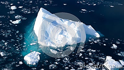 Iceberg shining in white, turquoise colors in dark blue water of Southern Antarctic Ocean, Antarctic Ocean Stock Photo