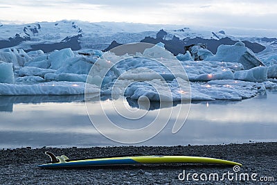 Icebergs with candles and serf board during the annual firework show at ice lagoon Jokulsarlon, Iceland Stock Photo