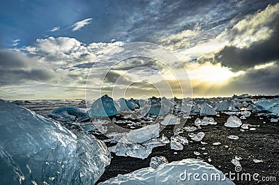Icebergs floating in Jokulsarlon at sunset golden hour with glac Stock Photo