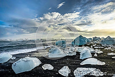 Icebergs floating in Jokulsarlon at sunset golden hour with glac Stock Photo