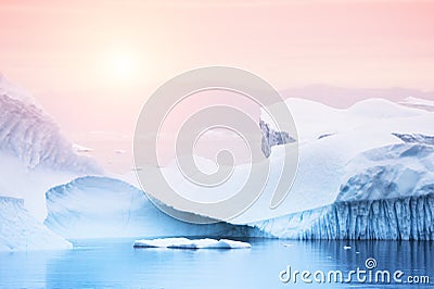 Icebergs on the shore of Atlantic ocean at sunset, Greenland Stock Photo