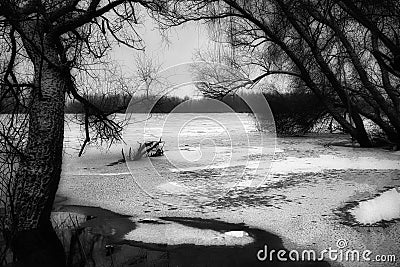 Icebound Symphony: Winter's Poetic Tale Along the Riverbanks Stock Photo