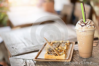 Iced coffee with Bread toast with chocolate sauce on wooden table Stock Photo