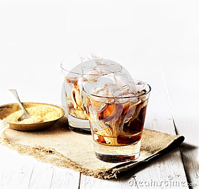 Iced coffee and cream, napkin, brown sugar on a white background Stock Photo